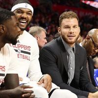 Blake Griffin in Street Clothes on the bench next to a Laughing Josh Smith