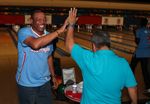 Doc Rivers high-fives a fan at the bowling alley
