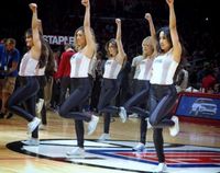 Clipper Spirit Dancers Raise their left arms in white top and black pants at Staples Center 2016