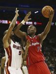 Lamar Odom in a Clipper red road jersey puts up a baby hook inside vs Rashard Lewis.JPG